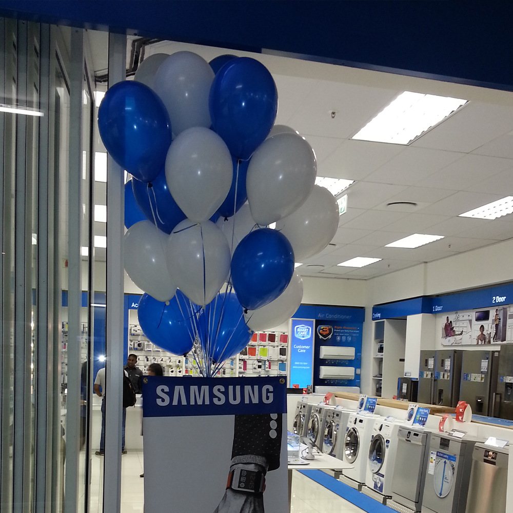 Blue and white balloon arrangement near Samsung display