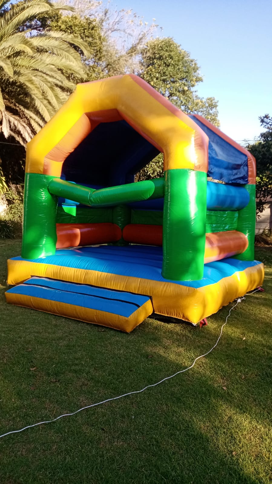 Colorful Mzansi Jumping Castle set up on grass