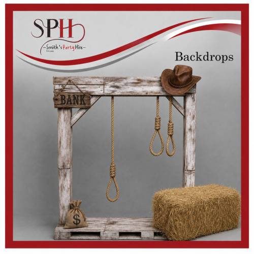 Rustic Wild West themed backdrop with straw bale, money bag, and nooses