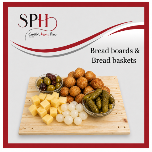 A wooden board with assorted cheeses, olives, pickles, and bread