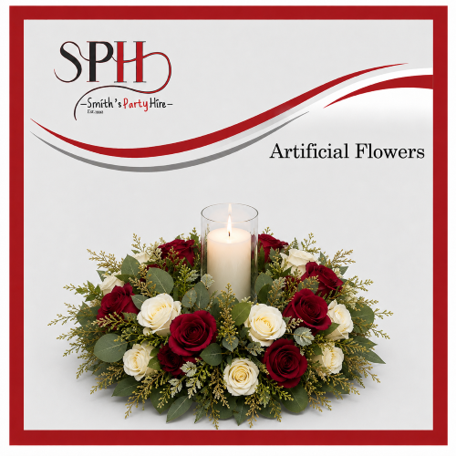 Artificial floral centerpiece with red and white roses and a candle