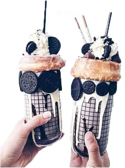 Two decorated milkshakes with toppings