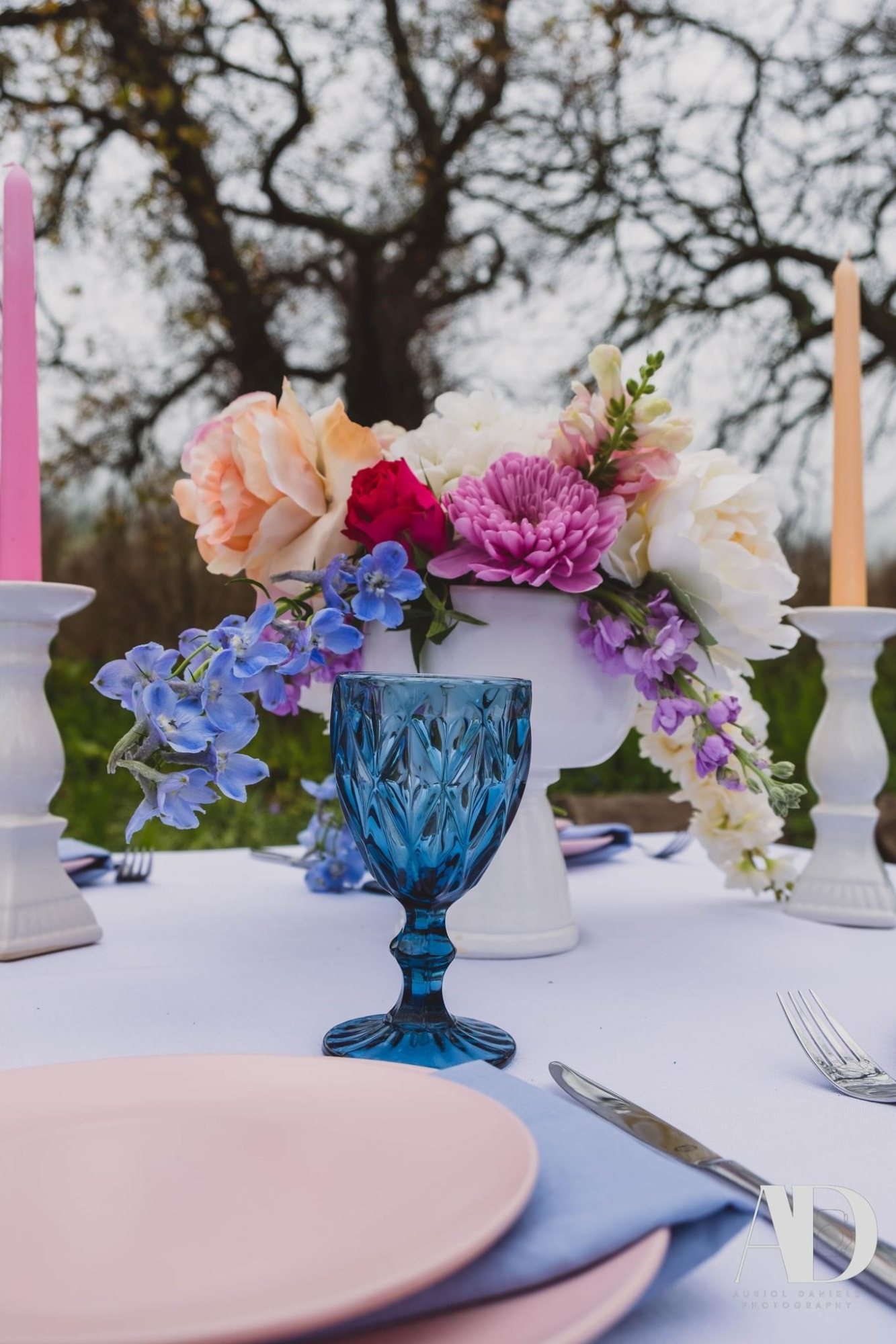 Table setting with blue goblet and floral centerpiece