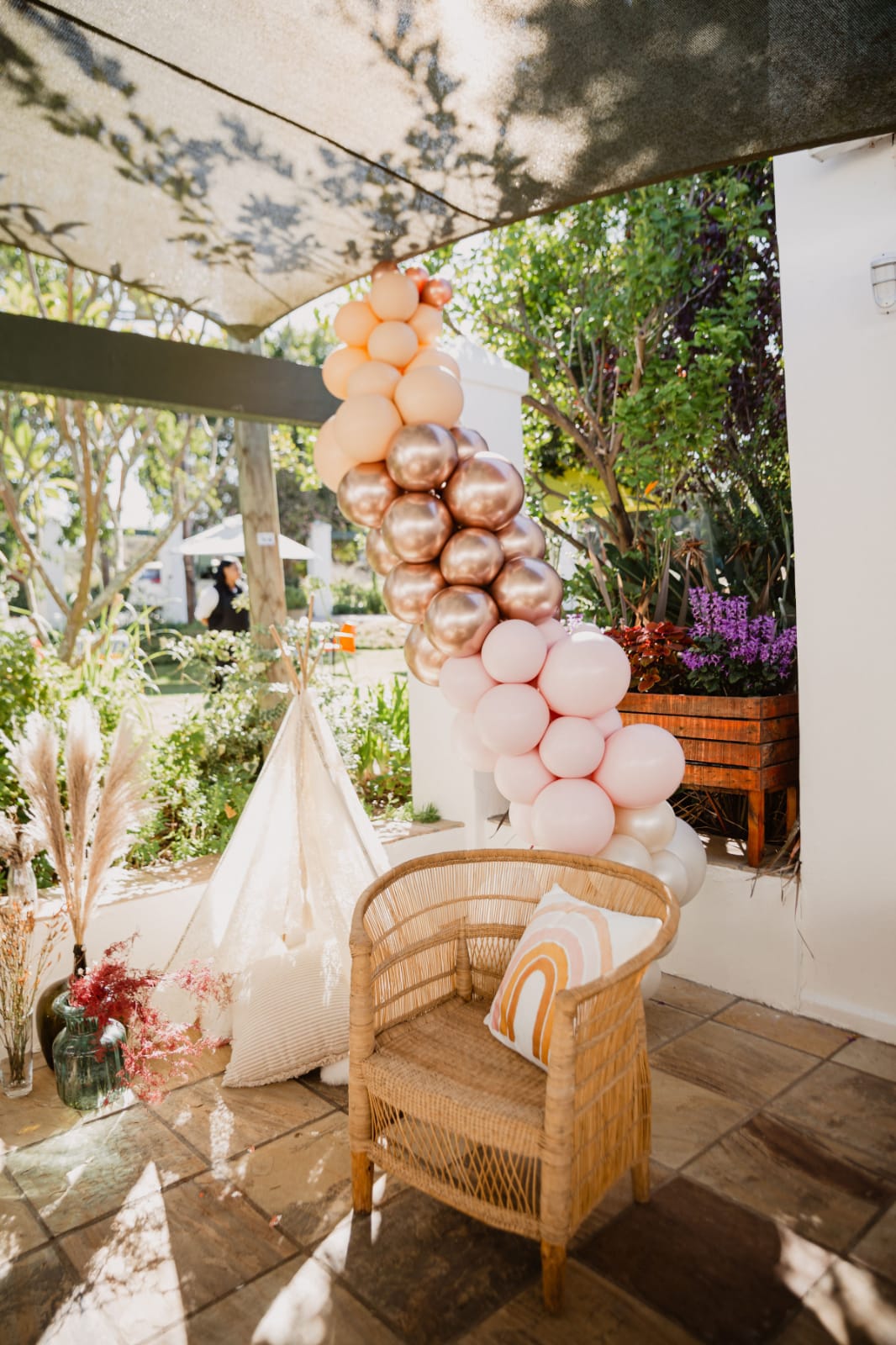 Colorful balloon installation near a decorative chair