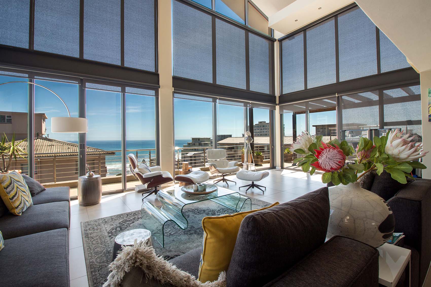 Spacious lounge with large windows and ocean view