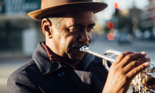 Musician playing a trumpet outdoors