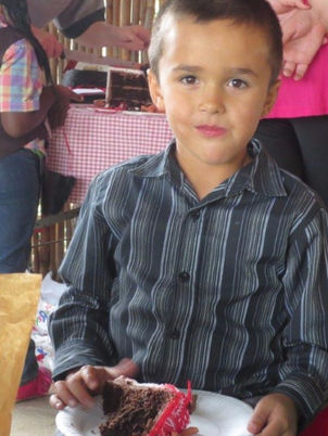 Child eating cake at a party