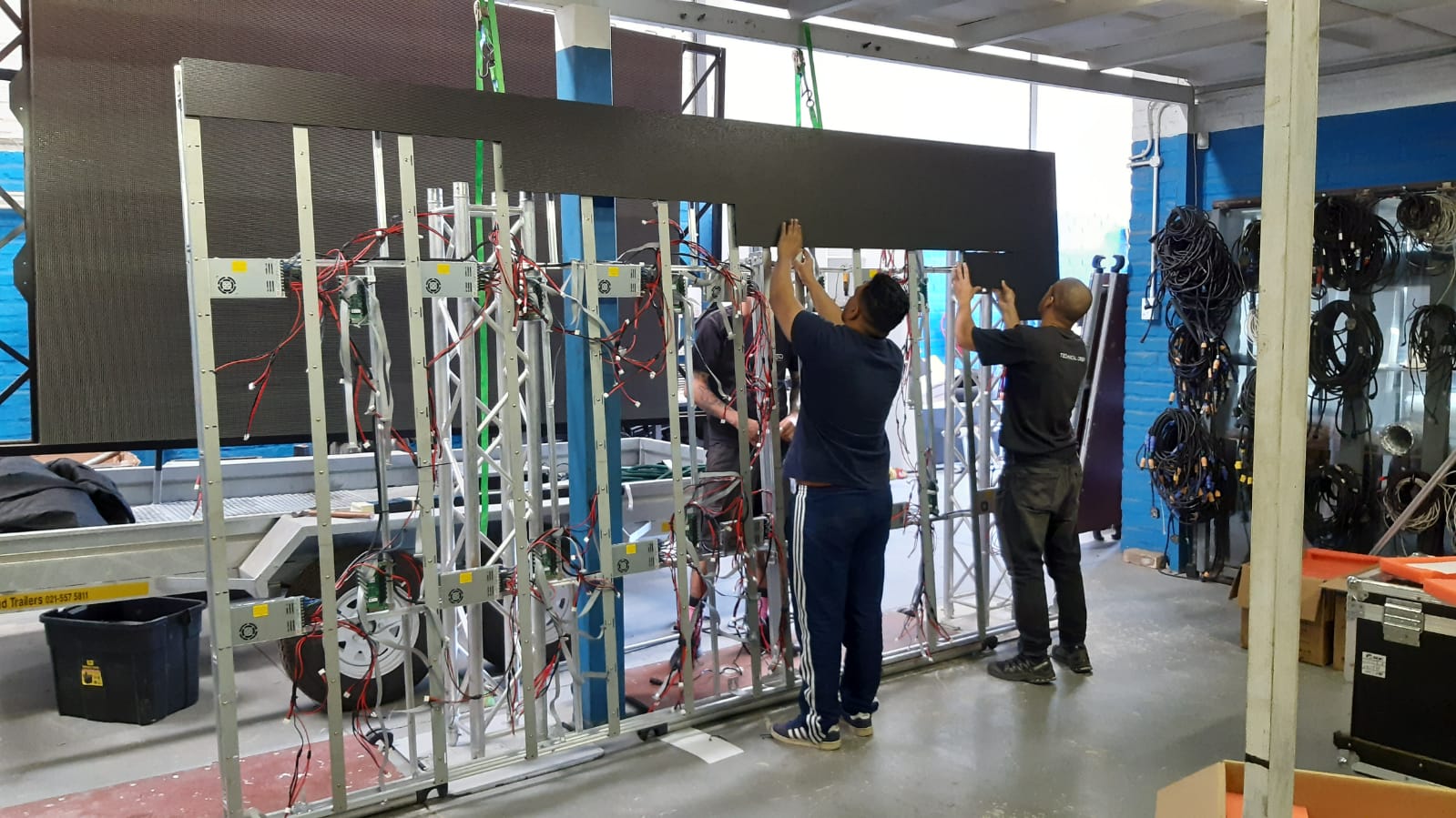 Technicians assembling an LED screen setup