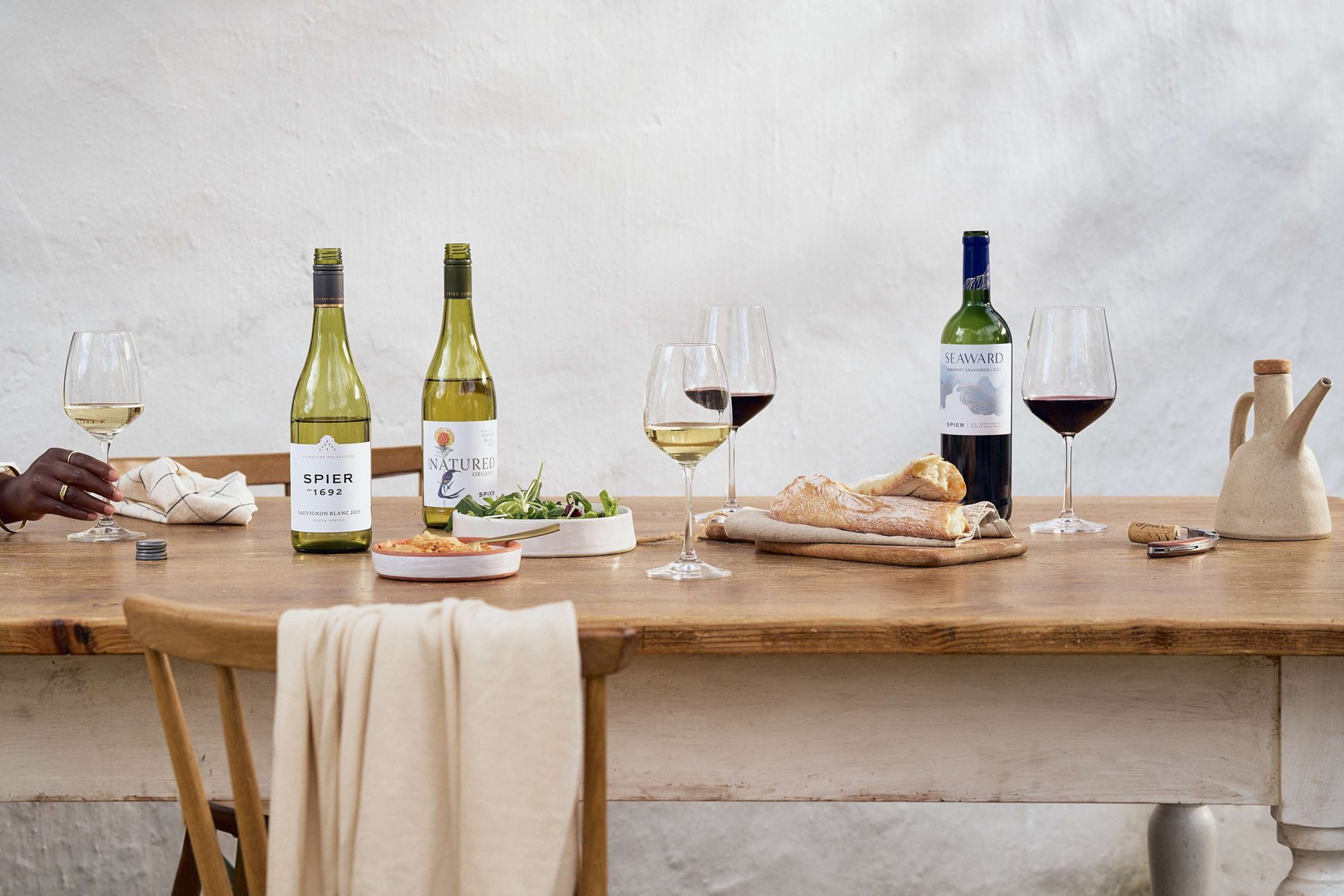 Table set for wine tasting with bottles and glasses