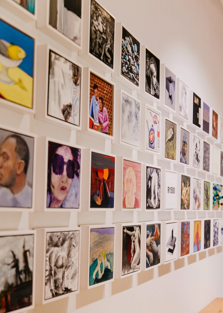 Gallery wall featuring various artworks for sale