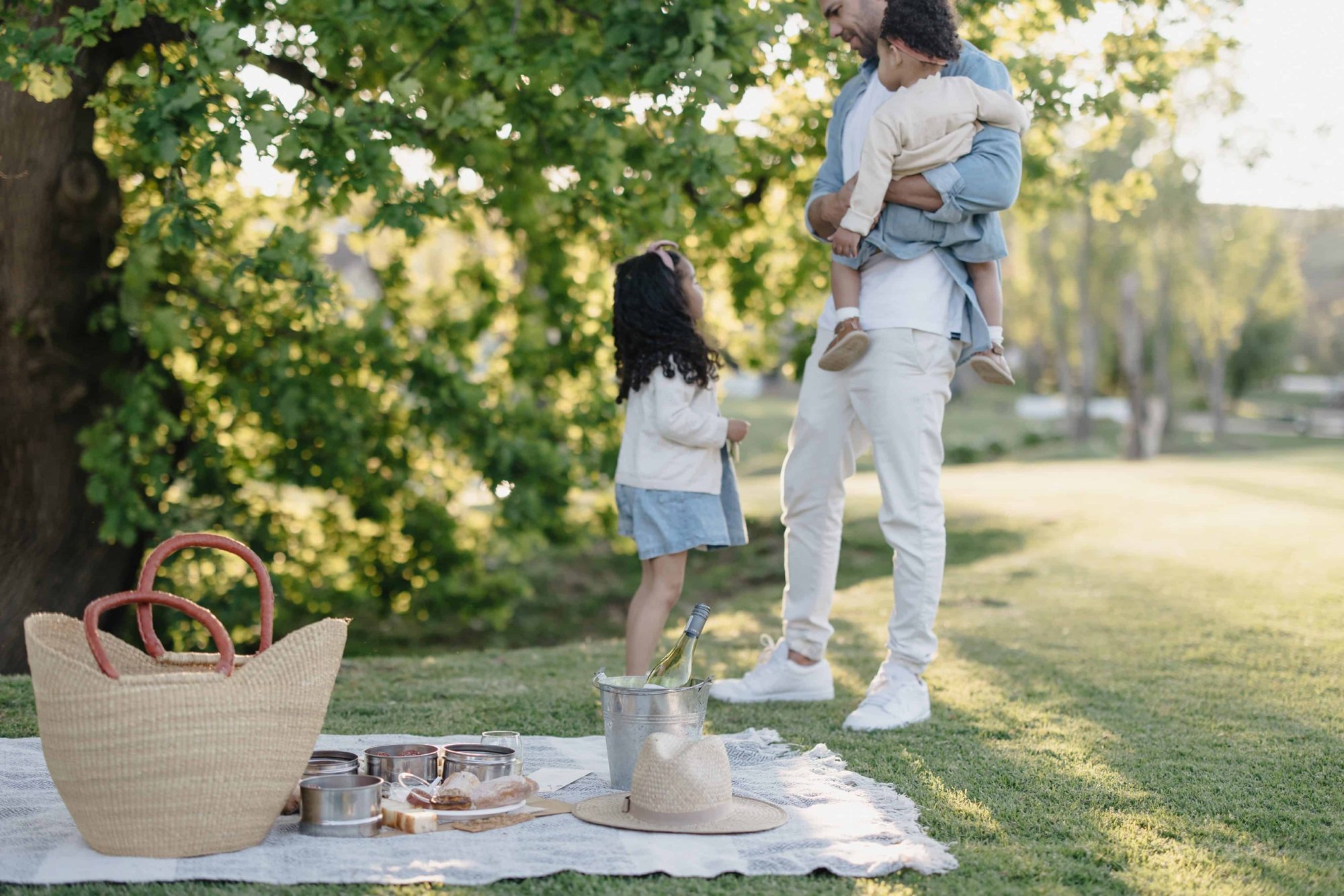 Family picnic setup with basket and food at Spier Wine Estate