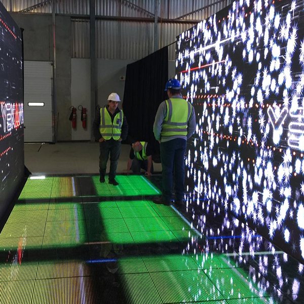 Technicians adjusting an illuminated LED floor and wall