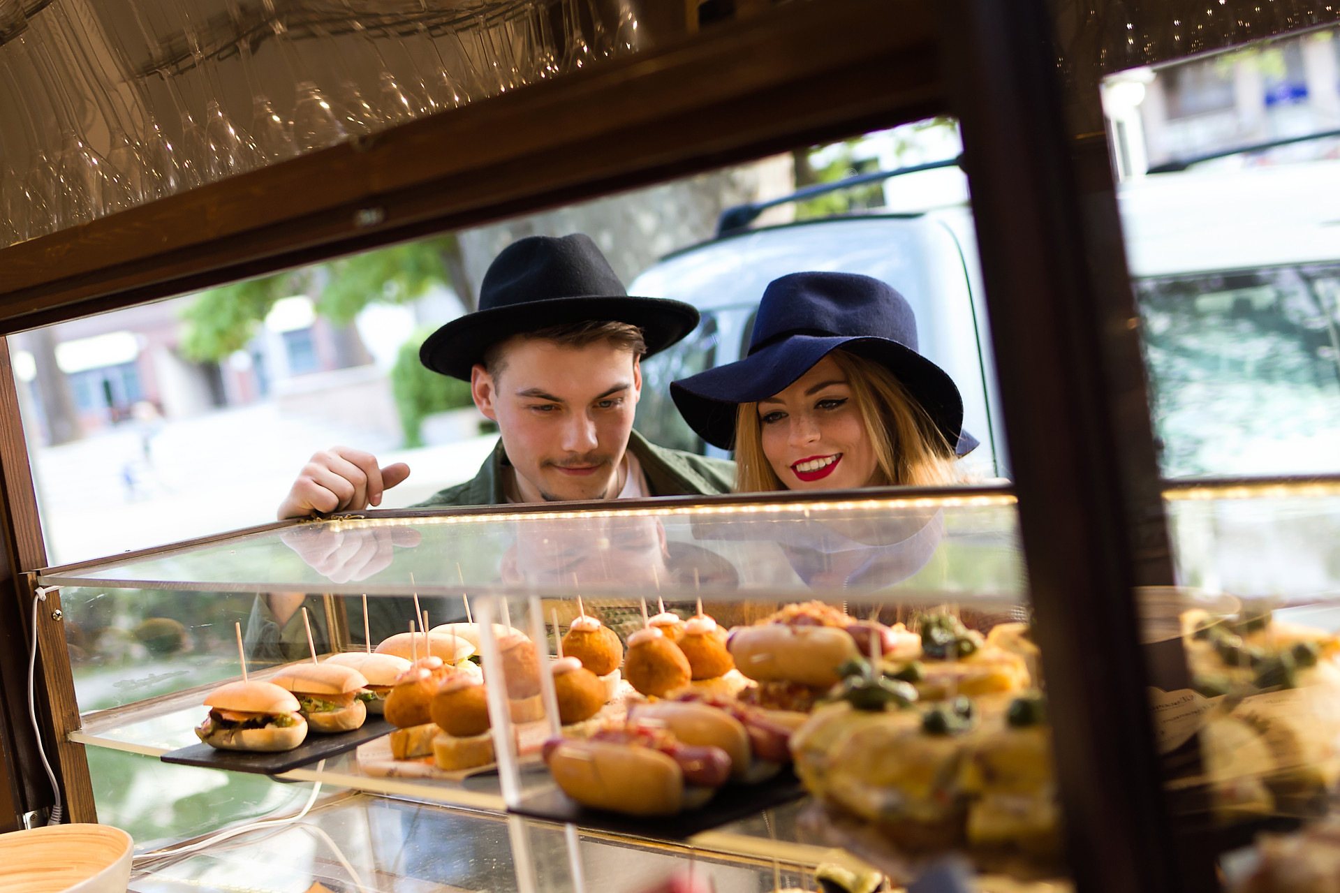 Couple looking at gourmet food selection in food truck