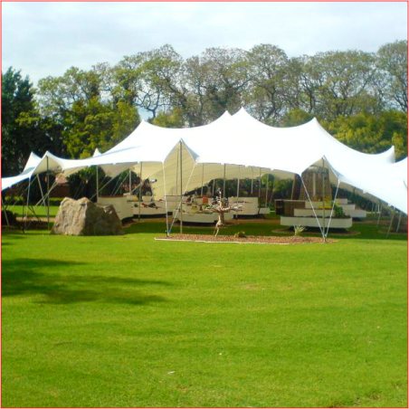 Large white stretch tent set up on a grassy area