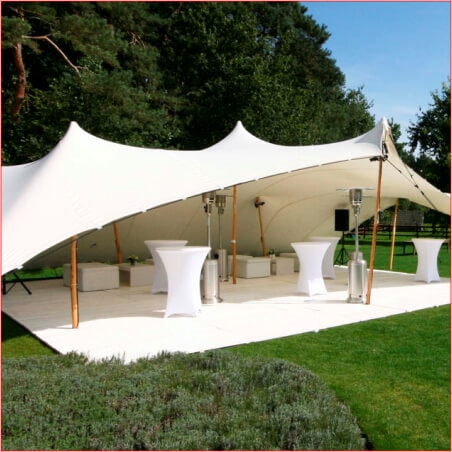 Outdoor setup of a stylish stretch tent with tables.
