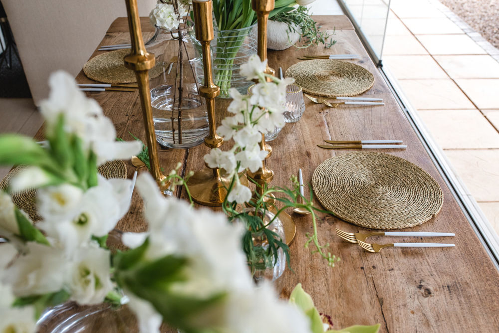 Elegant table setting with floral arrangements and gold accents