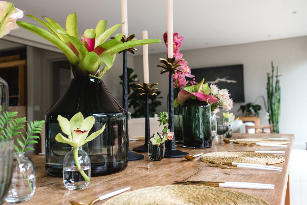 Stylish table setting with floral arrangements and decor.