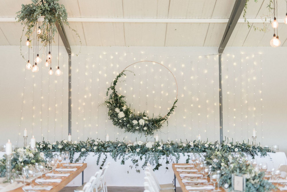 Floral backdrop with greenery and fairy lights