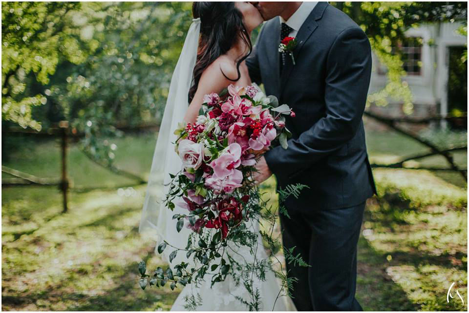 Bridal bouquet featuring orchids and lush greenery