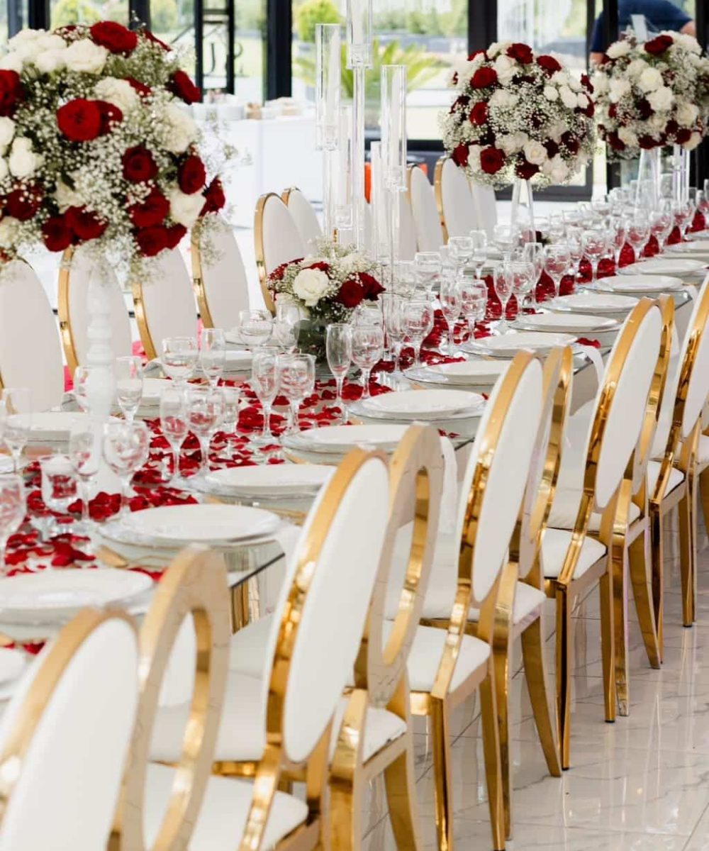 Elegant table setup with floral centerpieces and rose petals