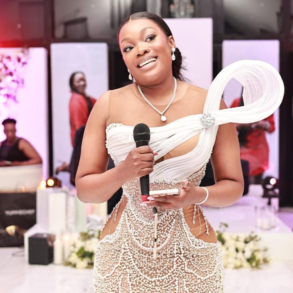 Woman in elegant dress giving a speech at an event