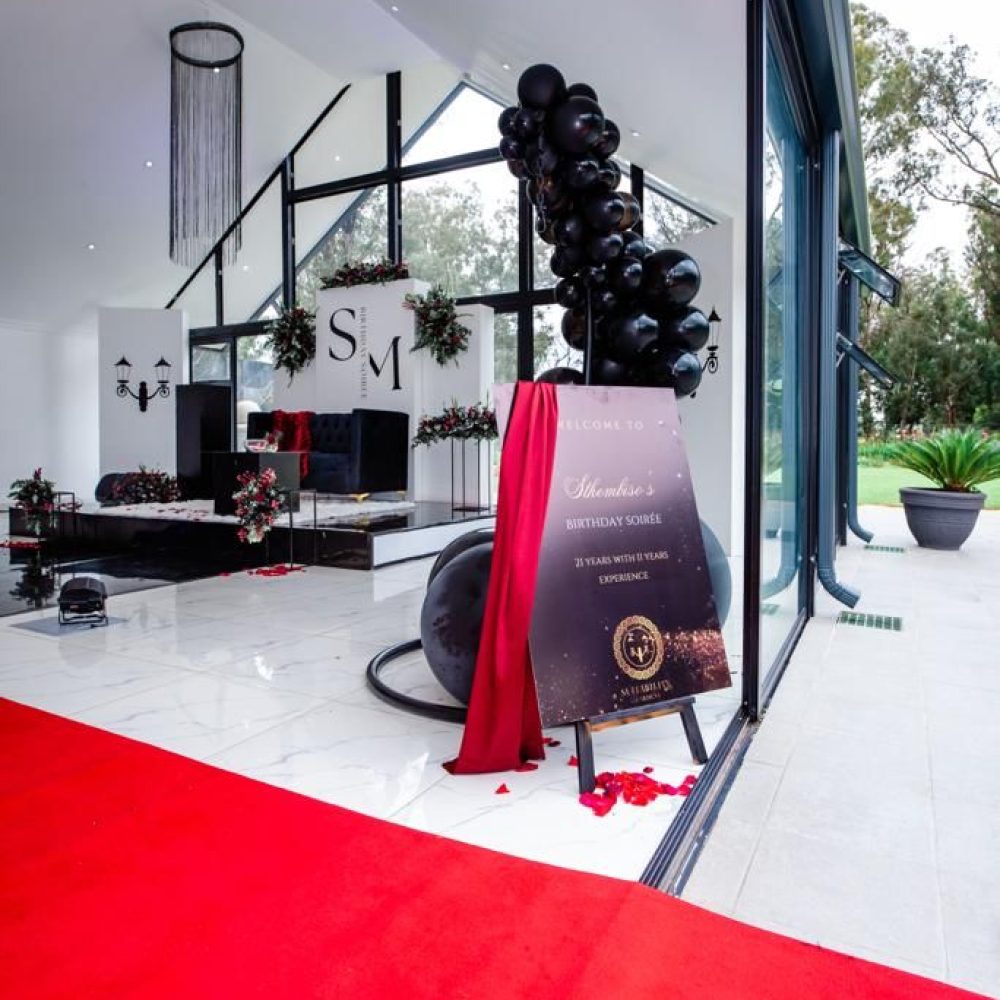 Event entrance with red carpet and decorative signage