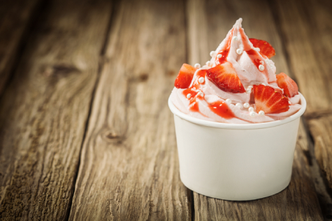 Cup of strawberry soft serve ice cream with toppings
