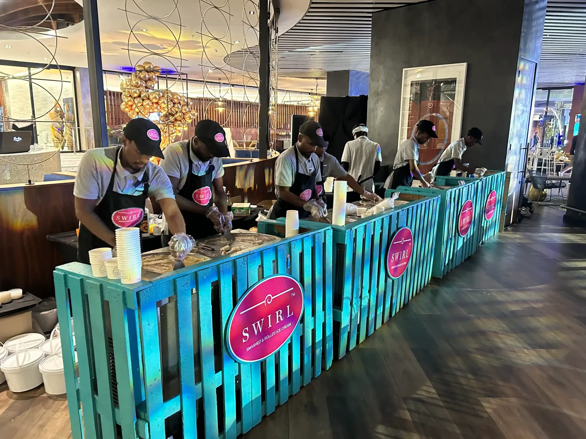 Swirl Ice Cream team at a rolling station preparing ice cream.