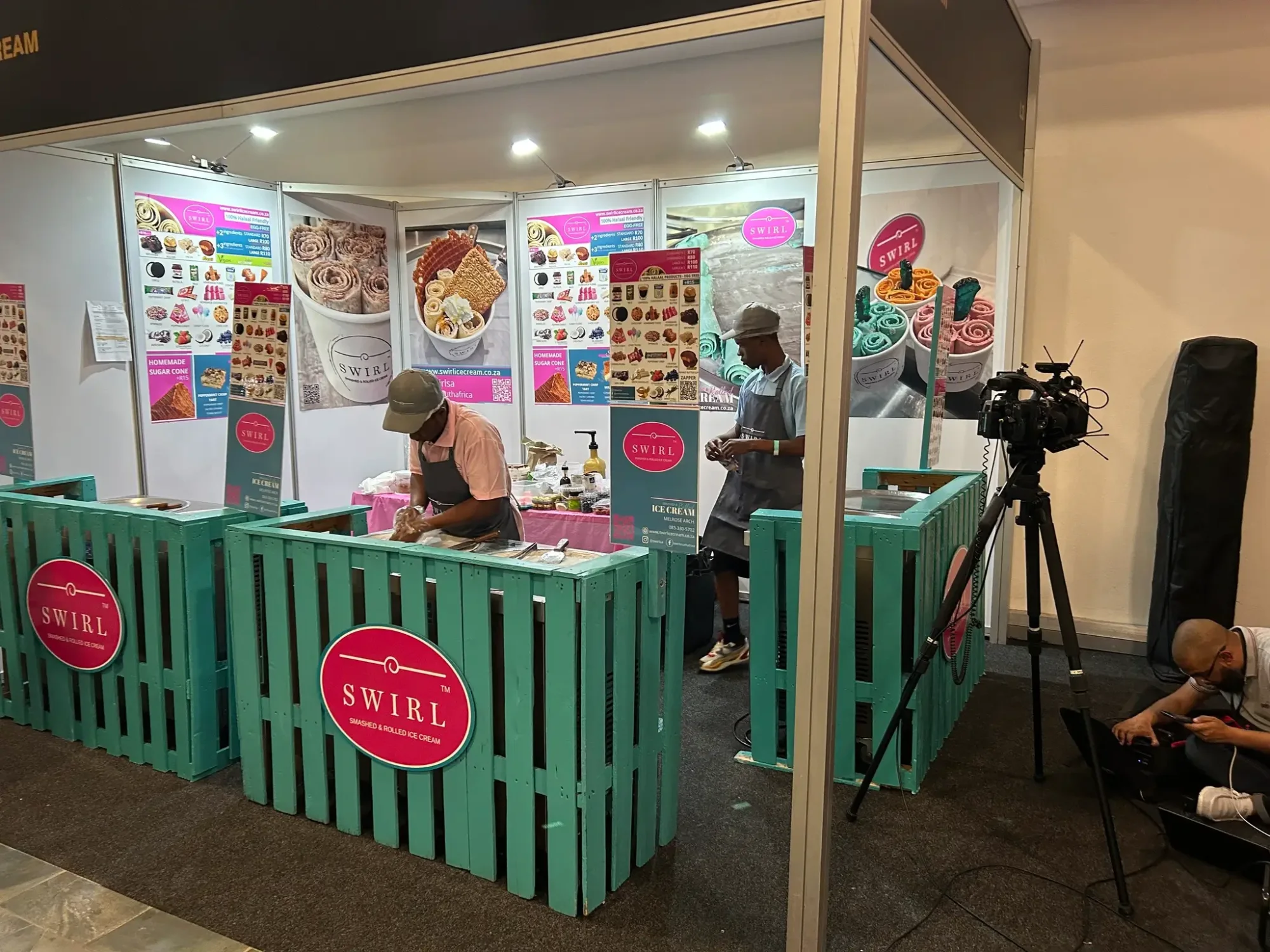 Swirl Ice Cream booth with staff making rolled ice cream.