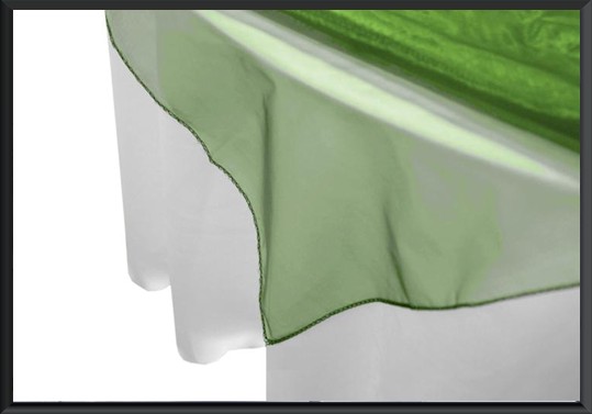 Close-up of a green table linen on a table edge.
