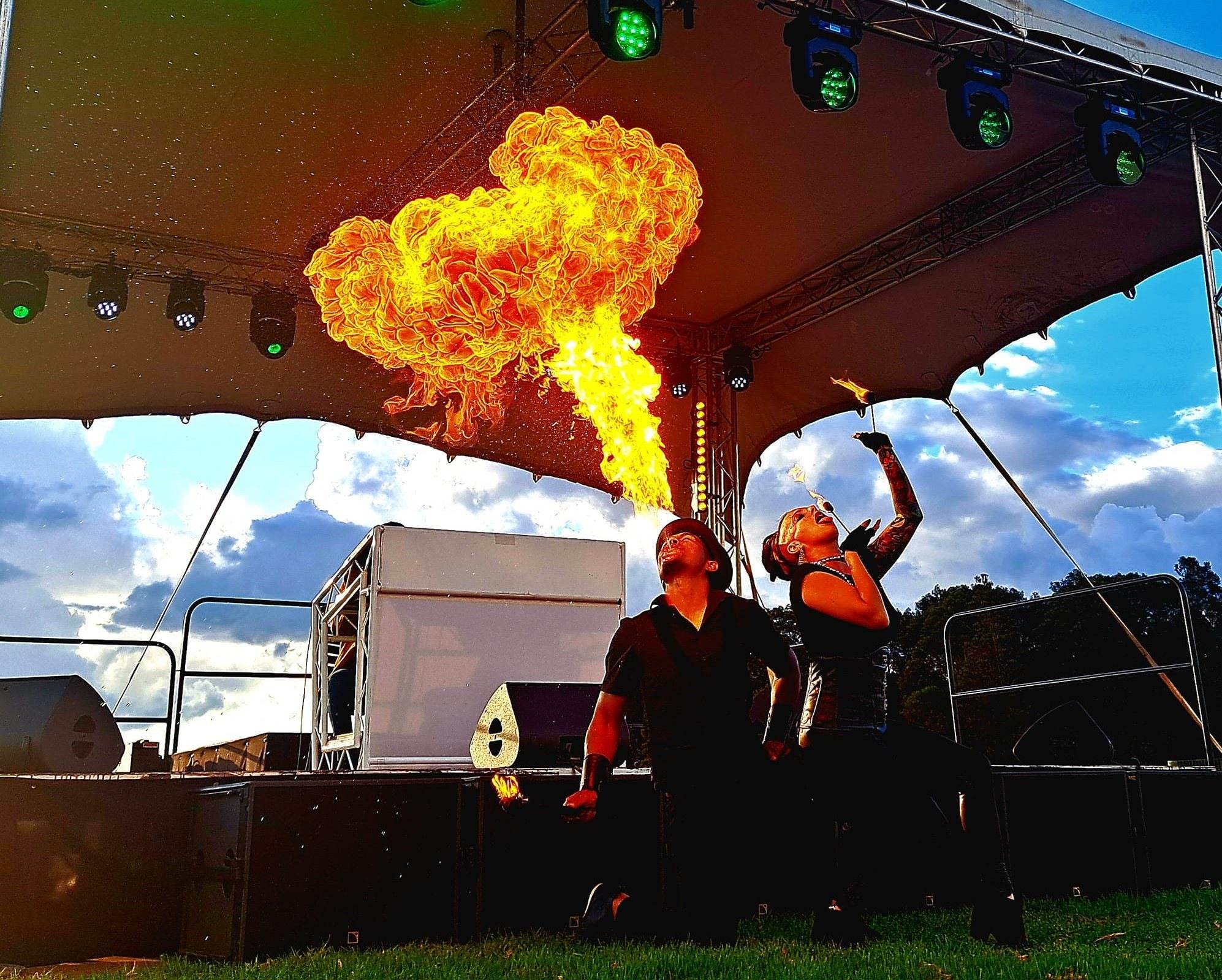 Fire performers showcasing a dramatic flame display on stage