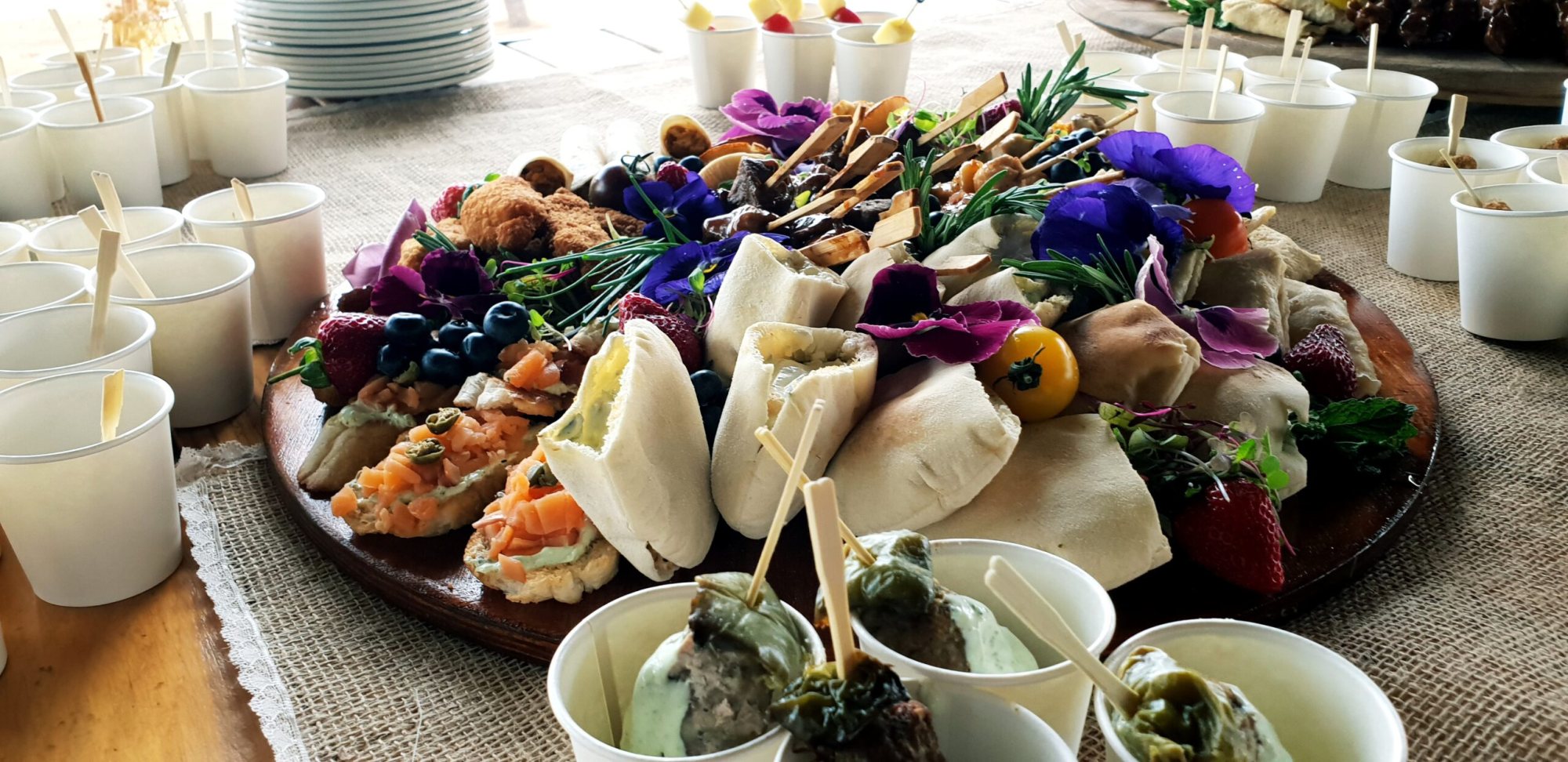 A gourmet platter featuring various appetizers and garnishes