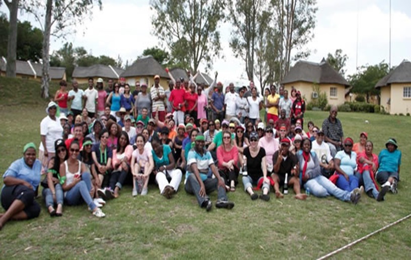 Group of people enjoying a team building event outdoors.