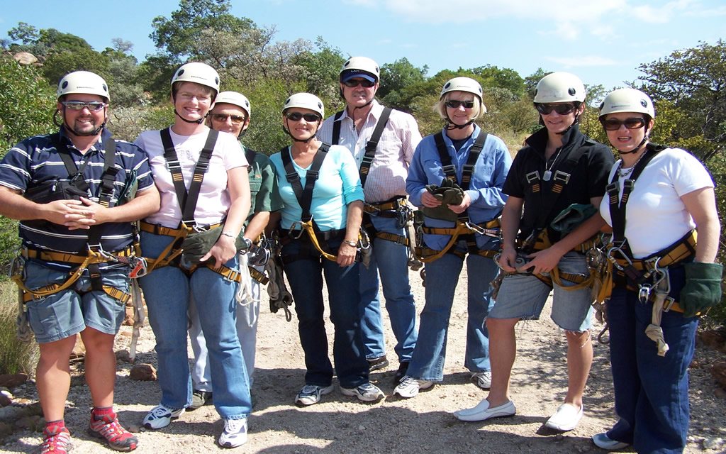 Group of people in harnesses ready for zip-lining