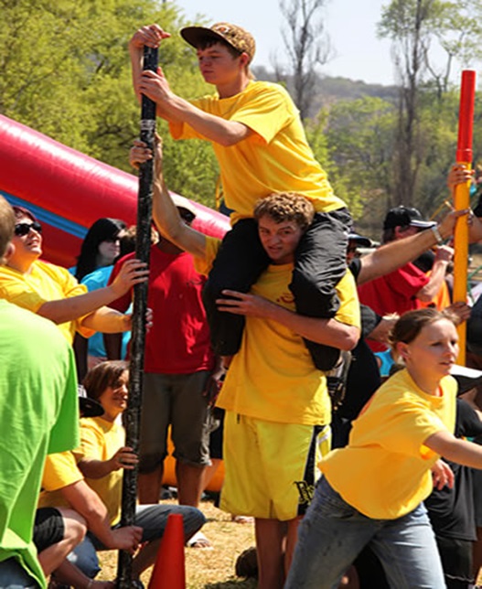 Group of people participating in outdoor team building activities