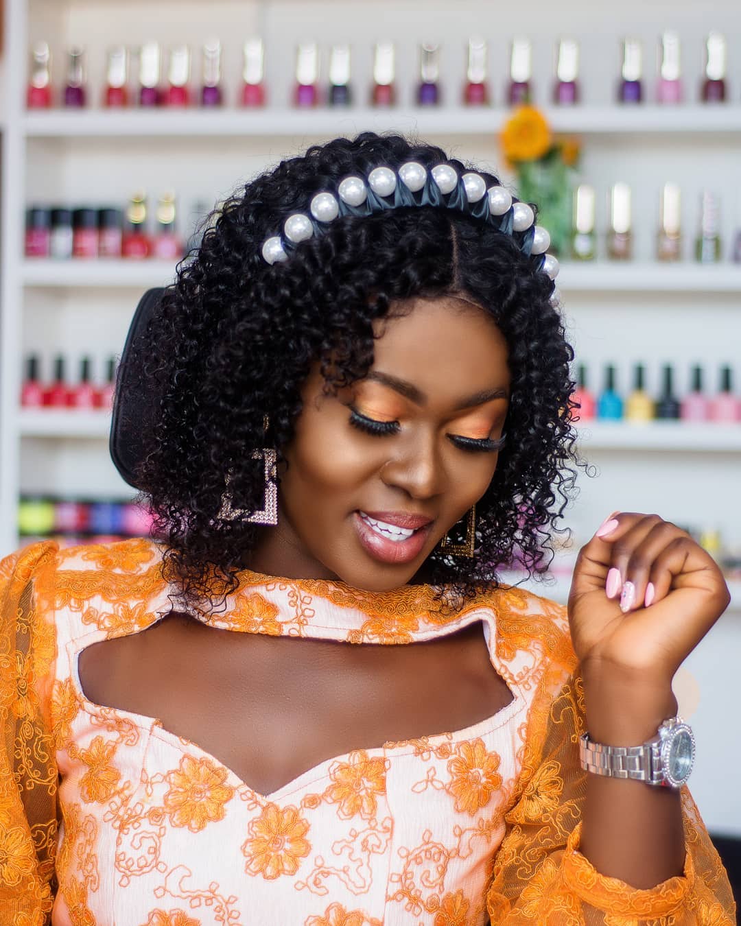 Portrait of a smiling woman with styled hair and makeup