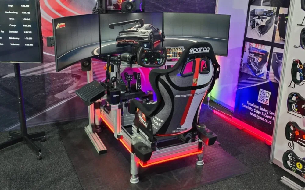 High-end racing simulator with three screens and ambient lighting.