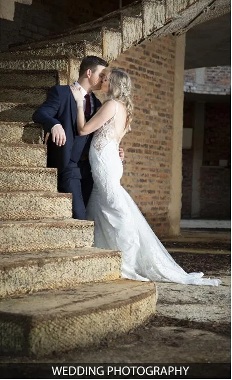 Couple embracing on a staircase during a wedding photoshoot