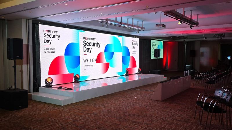 Stage setup with LED screens for a corporate event.