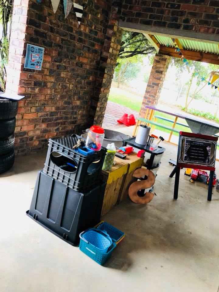 Outdoor catering area with table, kitchen equipment, and decor