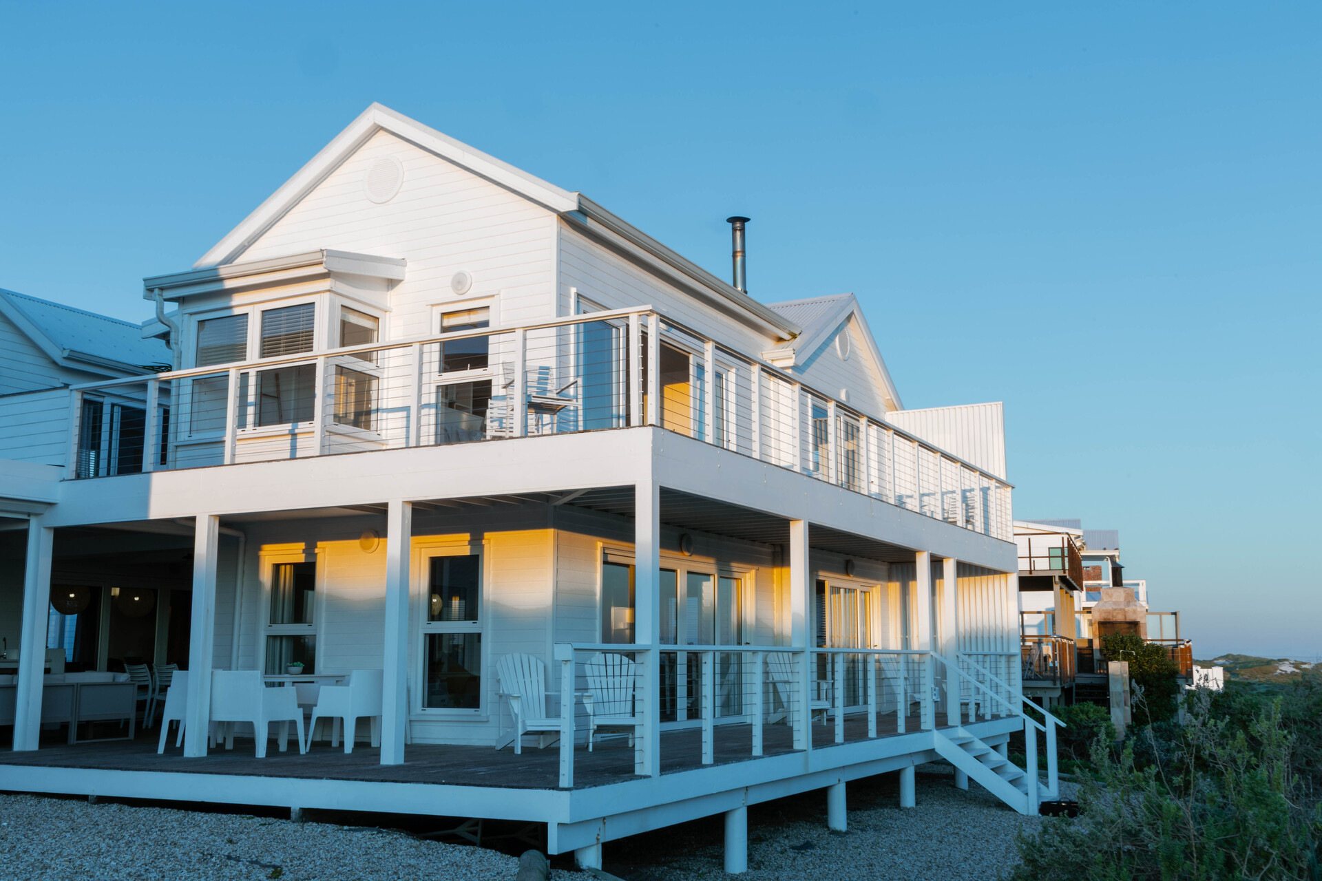 Beachfront house with clapperboard architecture and wooden deck