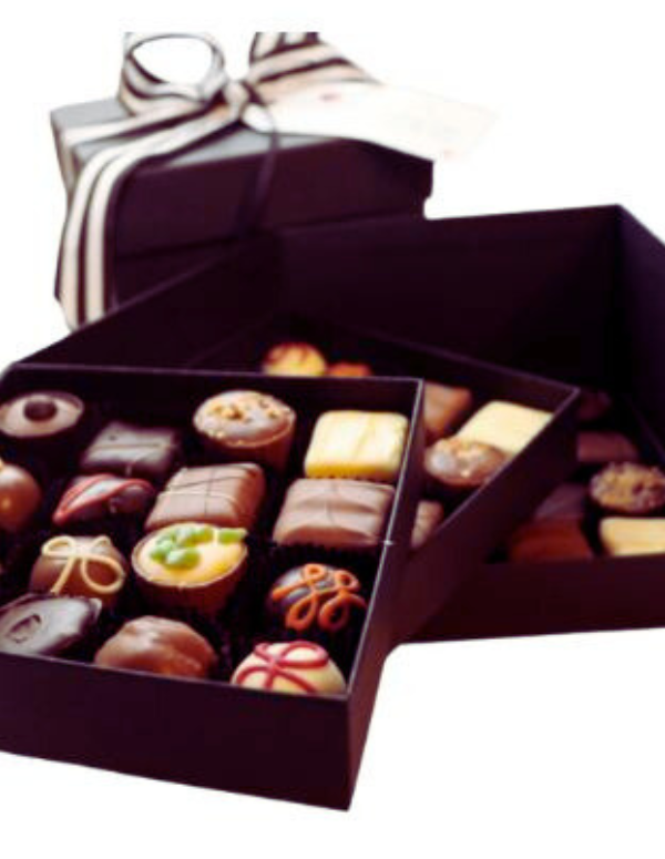 Box of assorted gourmet chocolates with a ribbon