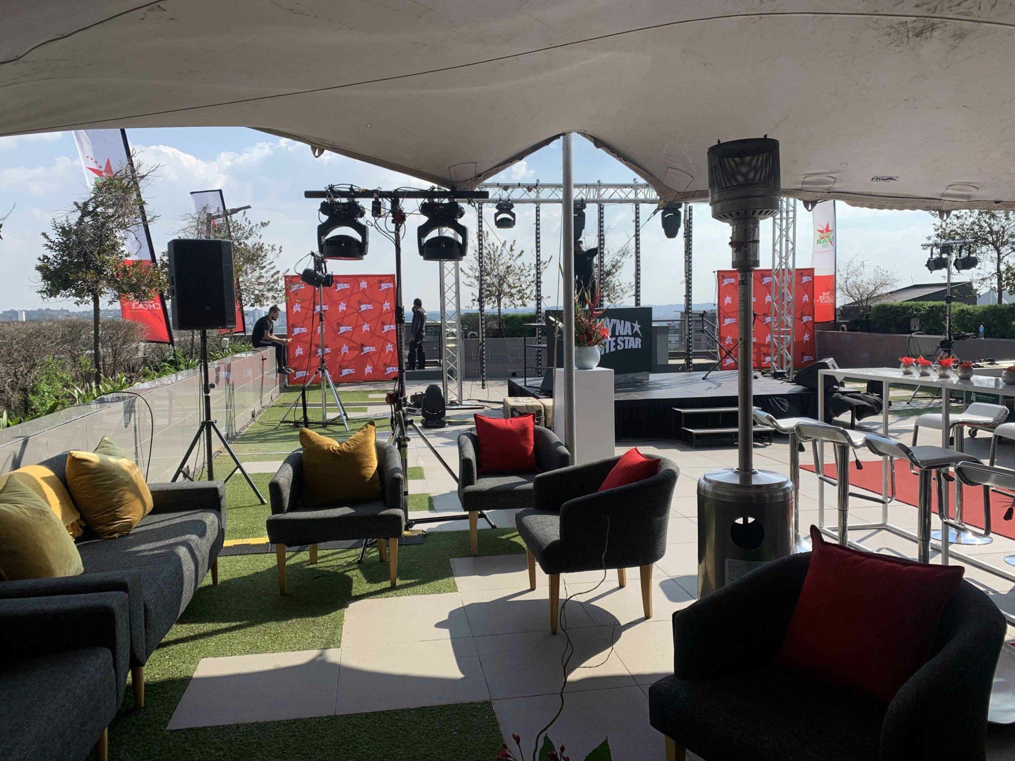 Rooftop event setup with seating and stage equipment