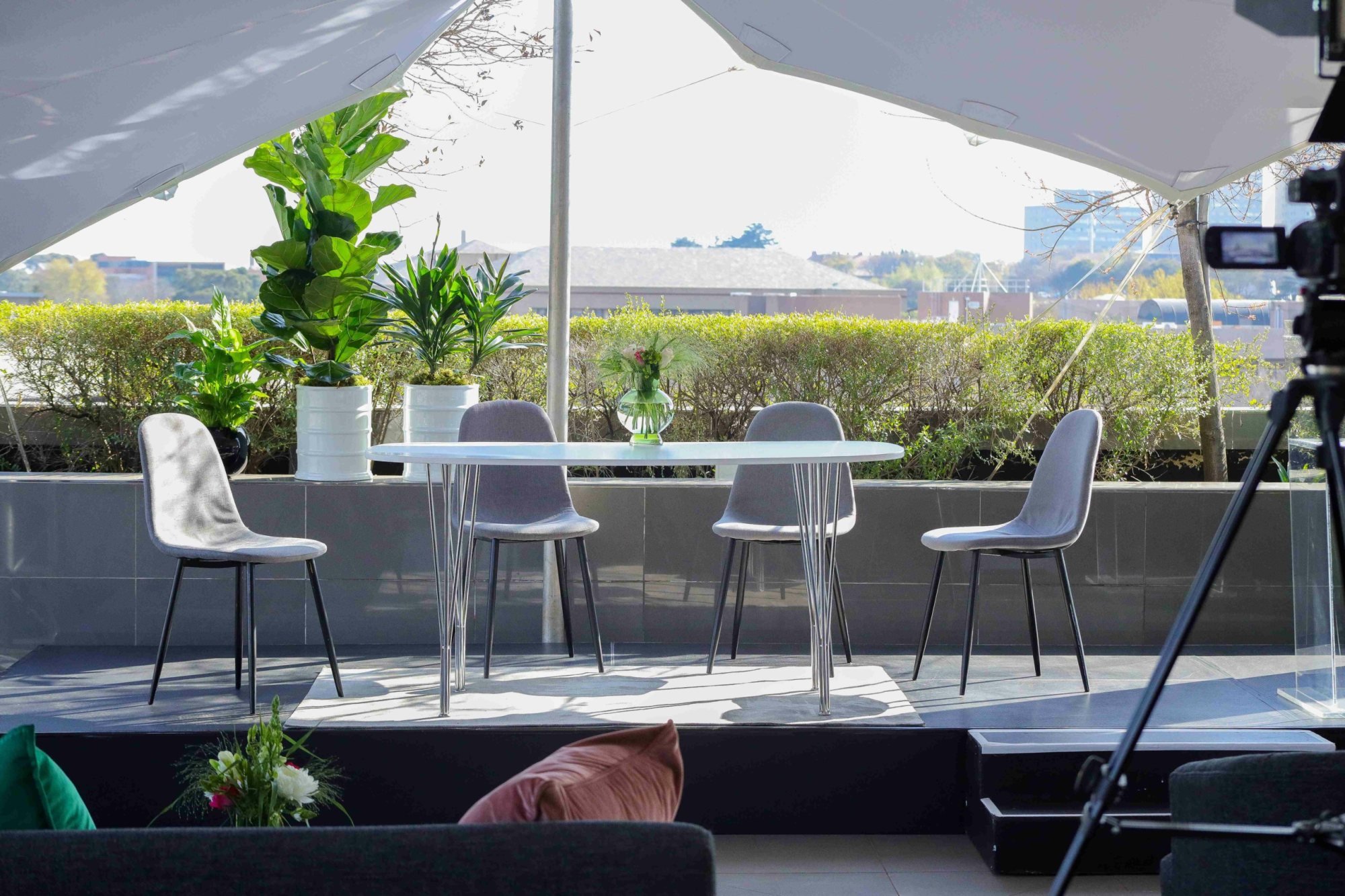 Rooftop seating arrangement with glass table and chairs