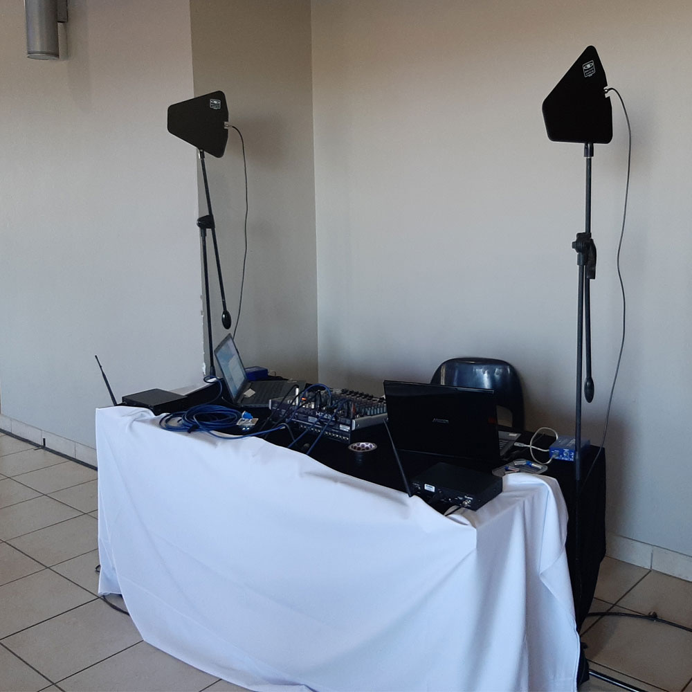 Audio visual setup with sound equipment and laptops