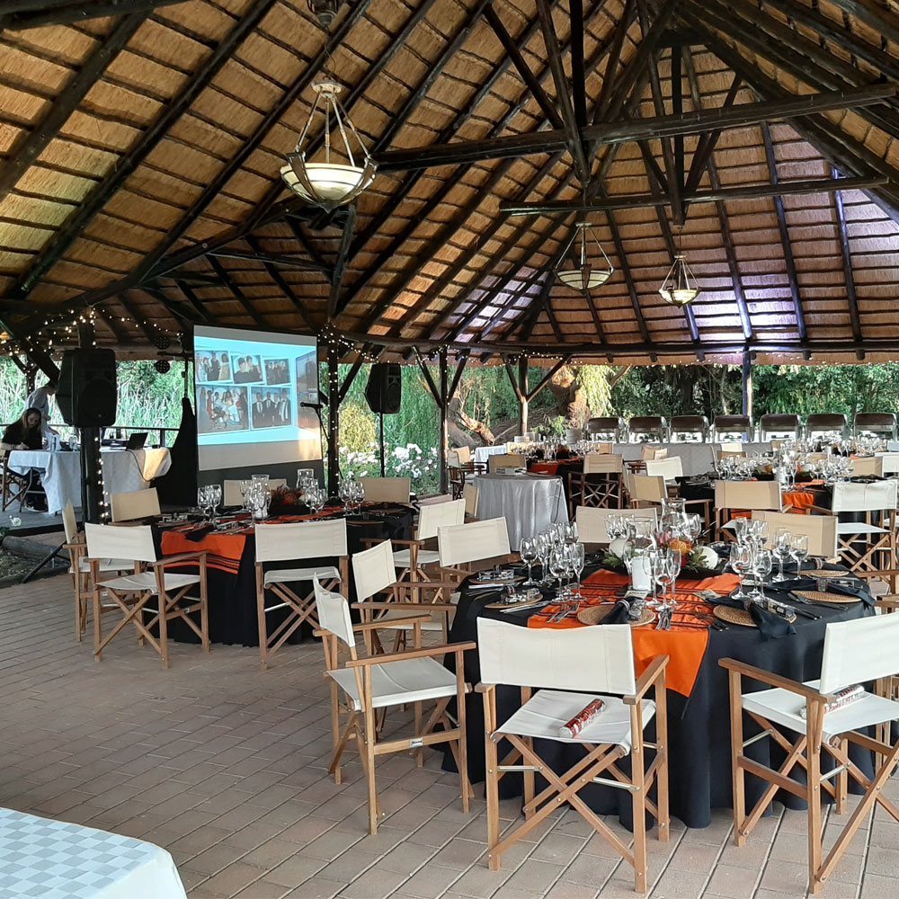 Dining setup with tables and chairs in an event space