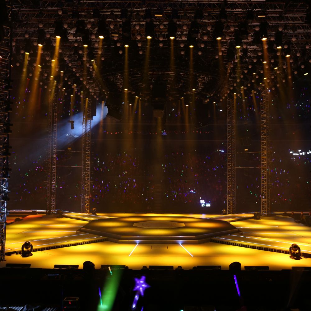 Brightly lit circular stage with surrounding lights