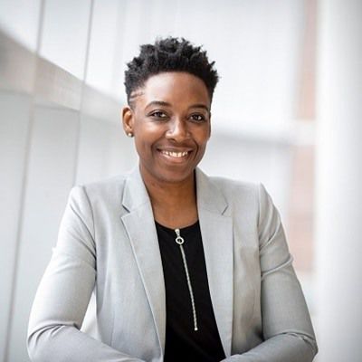 A professional woman smiling, representing team member at The Event Planner
