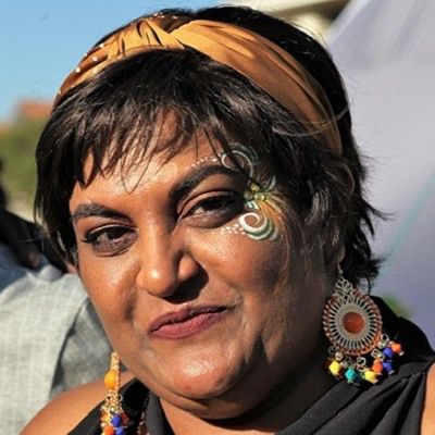 Woman with face painting and colorful earrings