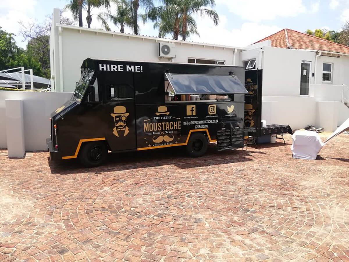 Mobile coffee bar parked next to a building